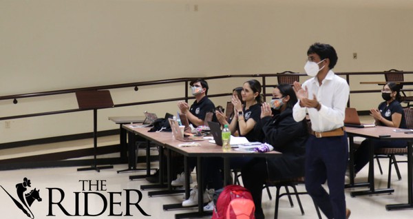 Members of the Student Government Association welcome new appointees, Kimberly Moran and Mariana Estevan during the Nov. 16 senate meeting on the Brownsville campus. Moran will serve as senator-at-large for Edinburg, and Estevan (seated, third from left), as sergeant-at-arms. Valeria Henderson/The Rider