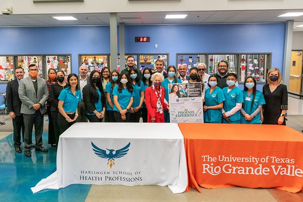 Photo of President Bailey, other people and eight grade students from the harlingen school of health professions photo by David Pike