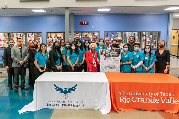 Photo of President Bailey, other people and eight grade students from the harlingen school of health professions photo by David Pike