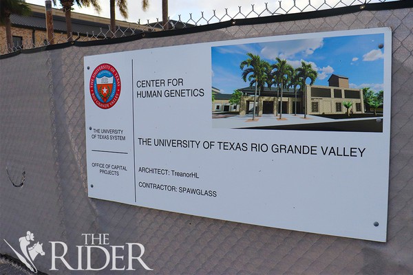 Sign on a fence at the Brownsville Campus that shows information about the new Center for Human Genetics