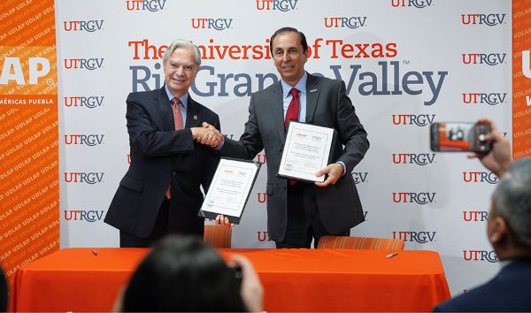 Dr. Luis Ernesto Derbez Bautista, president of Universidad de las Américas Puebla (UDLAP), and Dr. Can (John) Saygin, senior vice president for Research and dean of the Graduate College at UTRGV, shake hands after the signing of a collaborative research agreement. The collaboration aims to enhance regional competitiveness through a portfolio of applied research and development topics to be carried out jointly by faculty and students of UTRGV and UDLAP. (UTRGV Photo by Jesus Alferez)
