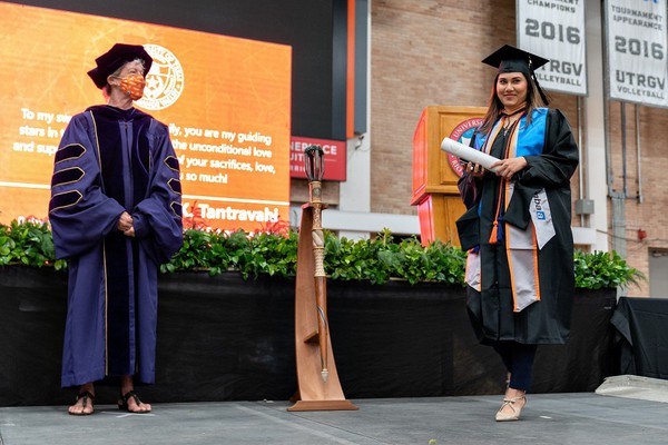 a woman walking on the stage and Dr. Linda Matthews,