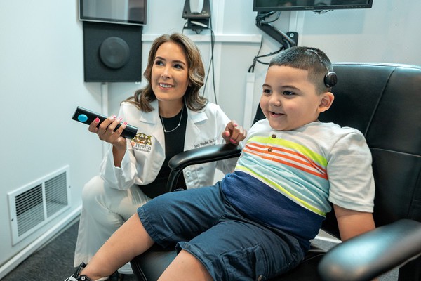Dr. Sandy Magallan, Au.D., UTRGV clinical assistant professor of Communication Disorders, who works with Eden Davila of Rio Grande City at the UT Health RGV Surgical Specialty in Edinburg. Eden has a cochlear implant and requires hearing services and consultations.