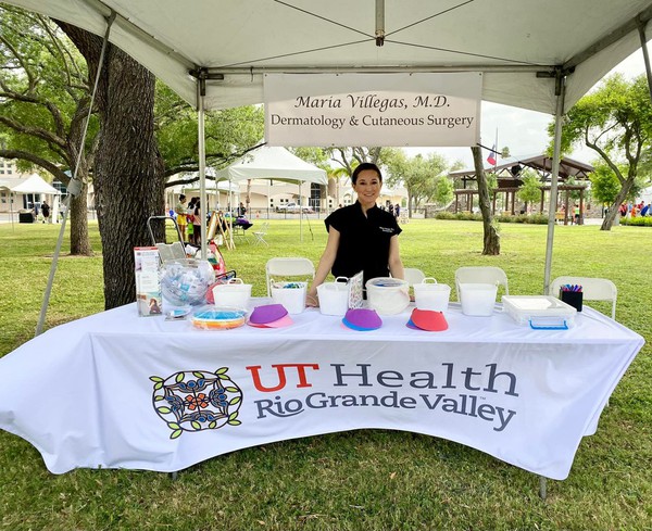 Maria Villegas M.D. at a booth dedicated to teaching others about the importance of protection against UV Rays.