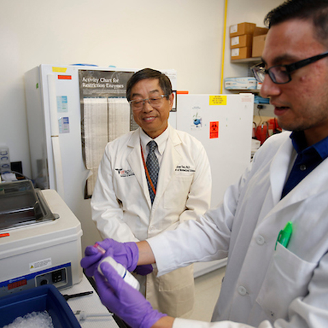 photo of two men in a UTRGV School of Medicine research lab, photo taken by Paul Chouy