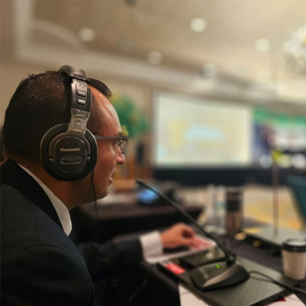 Interpreter at an Conference helping participants by Interpreting.