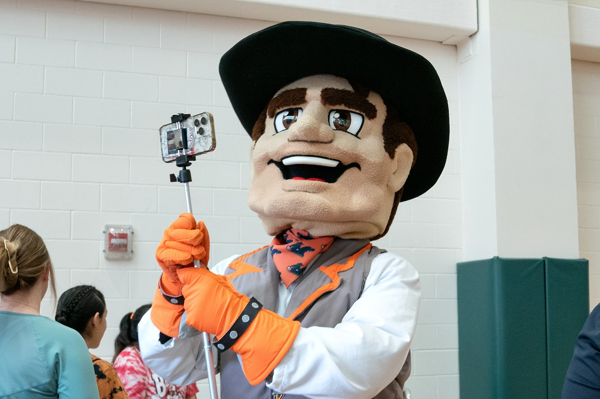Mascot taking photos with cellphone.
