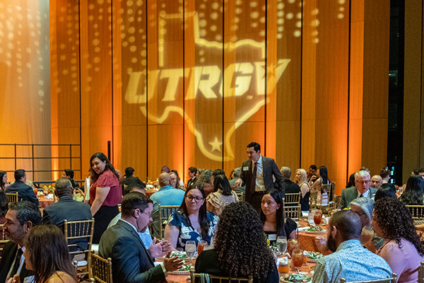 Photo of the UTRGV logo projected onto a wall during an event.